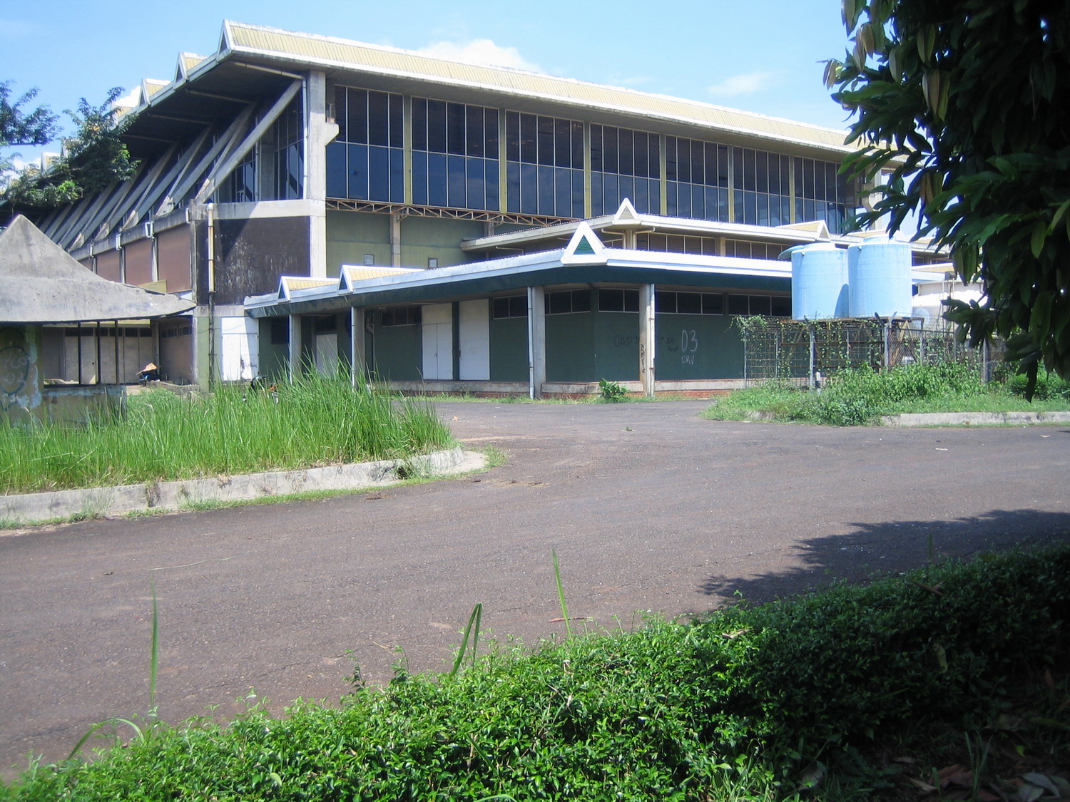 Puspiptek research building with sawtooth roof and mature landscape